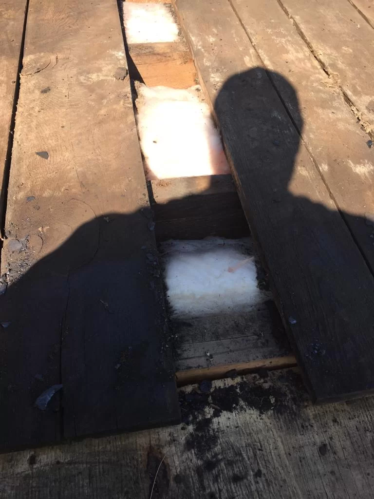Attic inspection and blown-in insulation above a flat roof in Toronto, view 2