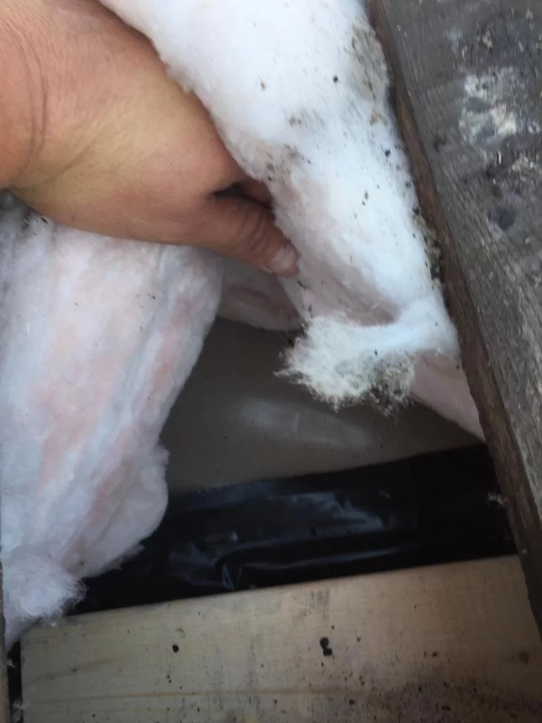 Attic inspection and blown-in insulation above a flat roof in Toronto, view 3