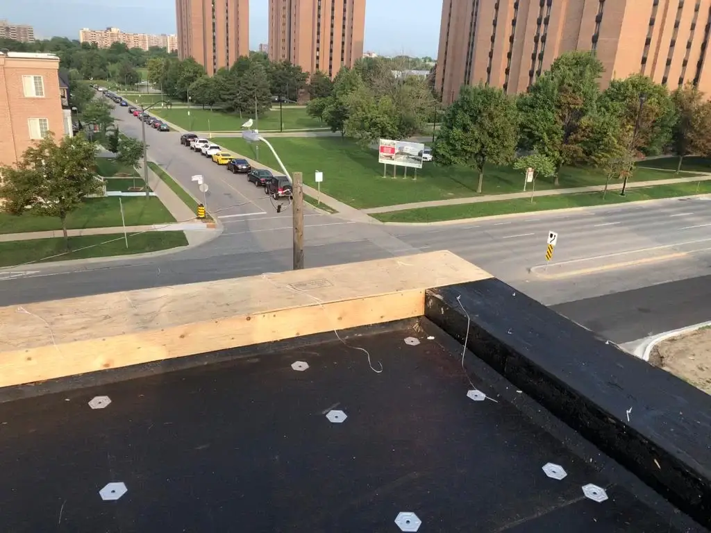 Parapet wall repair and reflashing on a Toronto flat roof, view 2
