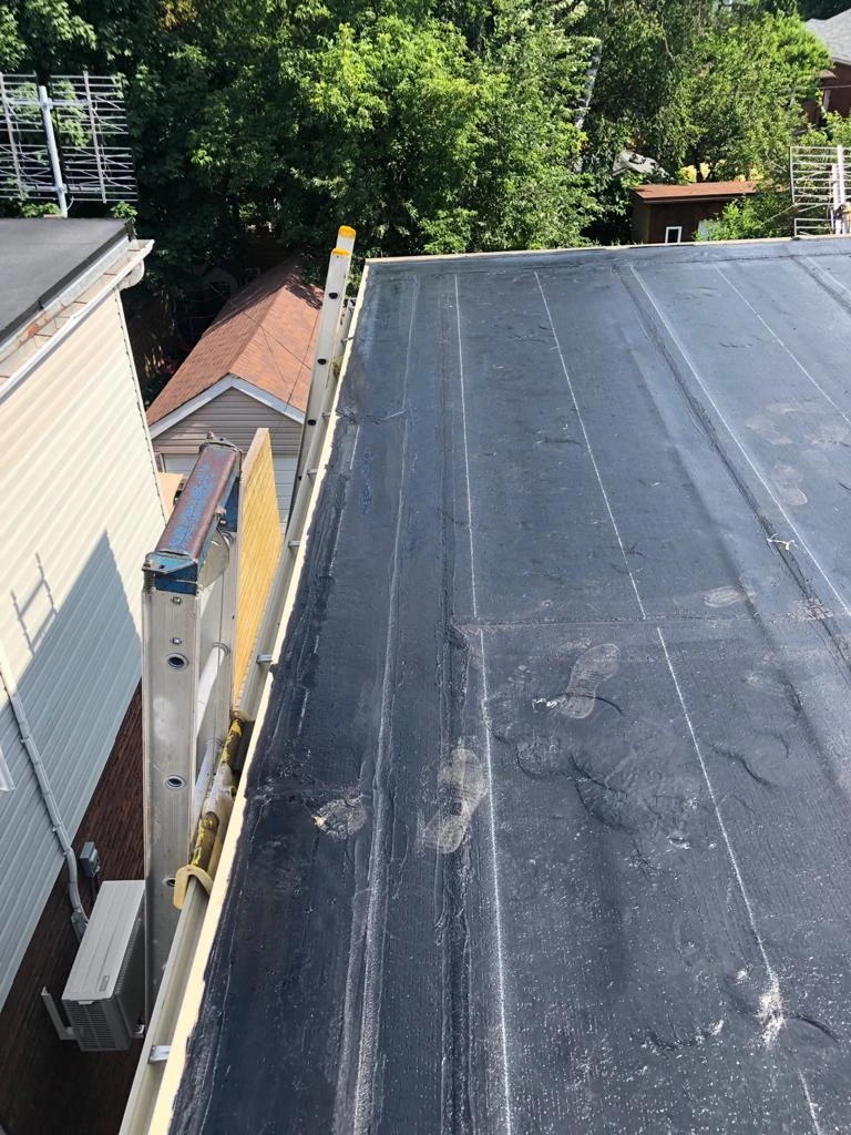 Flat Roofs Toronto roofing crew working on a flat roof, view 2