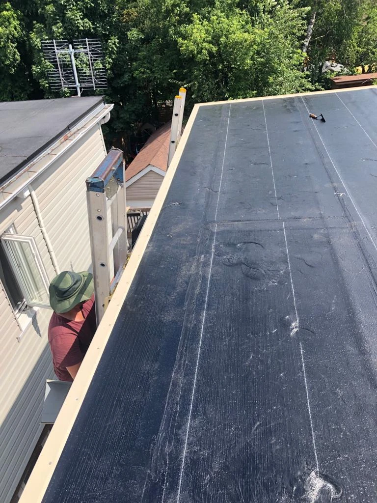 Flat Roofs Toronto roofing crew working on a flat roof, view 1